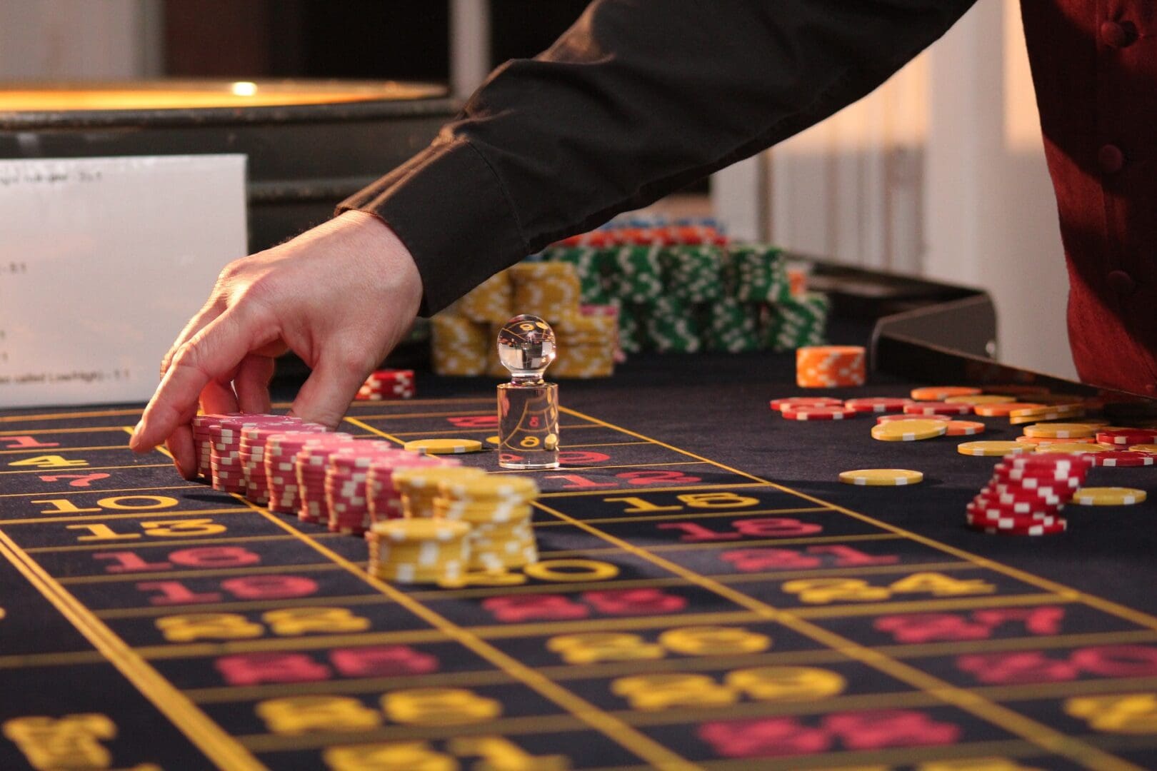 A person is playing roulette on the table.