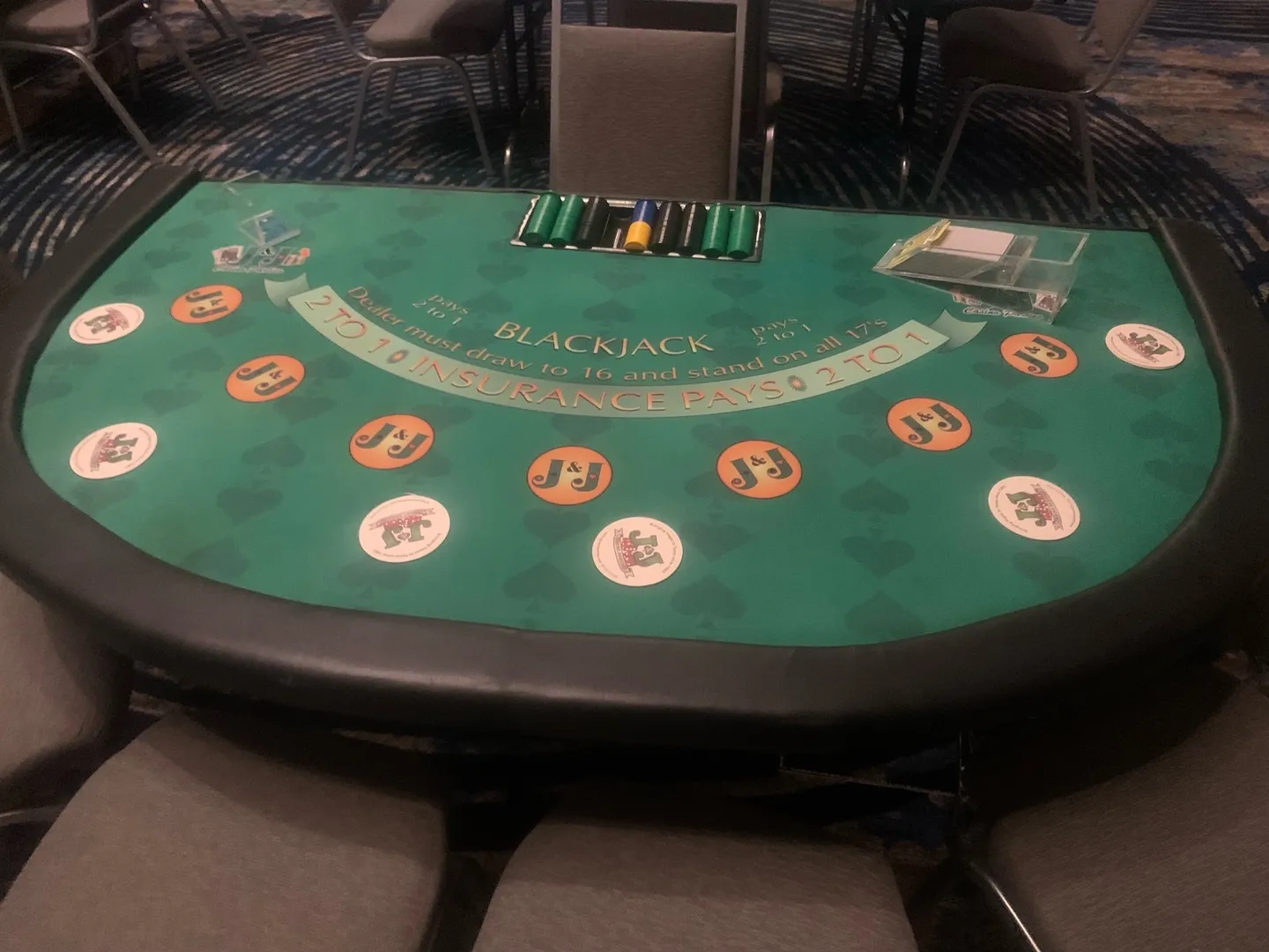 A table with a green cover and orange numbers