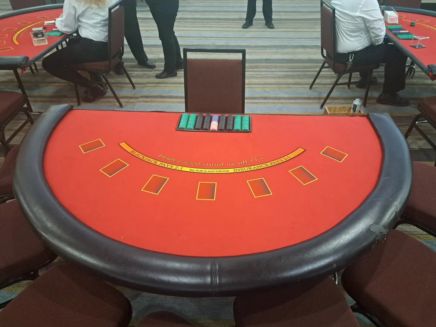 A table with cards and chairs around it